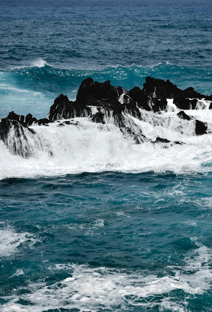 ocean waves crashing on rock formation
